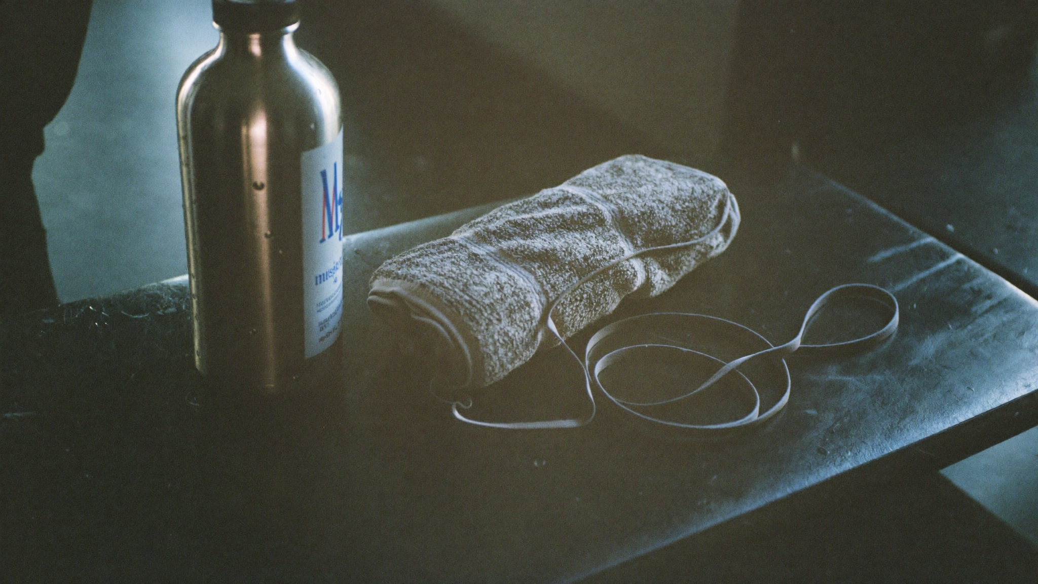 Picture of Steel bottle, towel, and rope on a gym bench